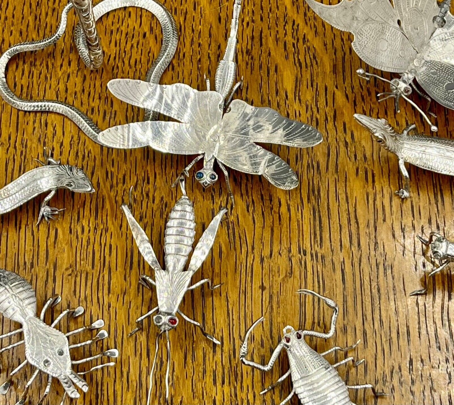 A collection of 9 silver insects and reptiles - lizard - snake - bugs etc