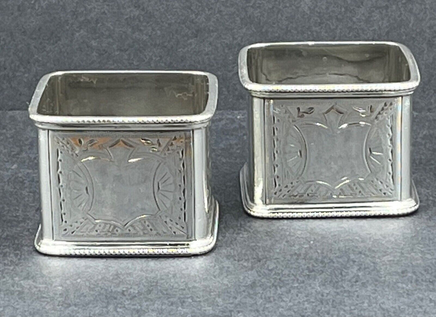 A good quality pair of Victorian sterling silver square napkin rings London 1888